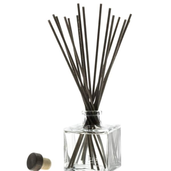 Clear square glass reed diffuser with black reeds and a cap