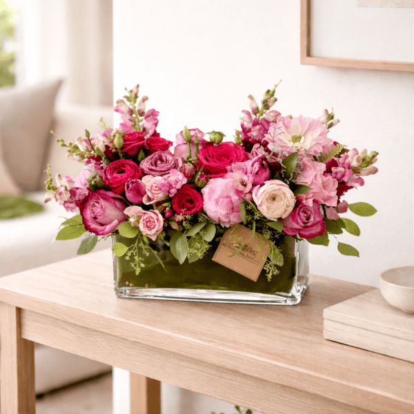 Pink and magenta flower arrangement in a glass vase