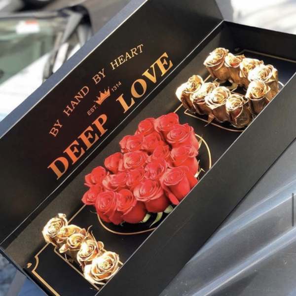 Boxed arrangement of red and gold roses with "Deep Love" text