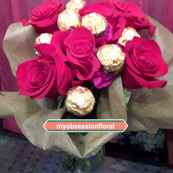 Bouquet of hot pink roses with gold-wrapped chocolates in burlap wrap