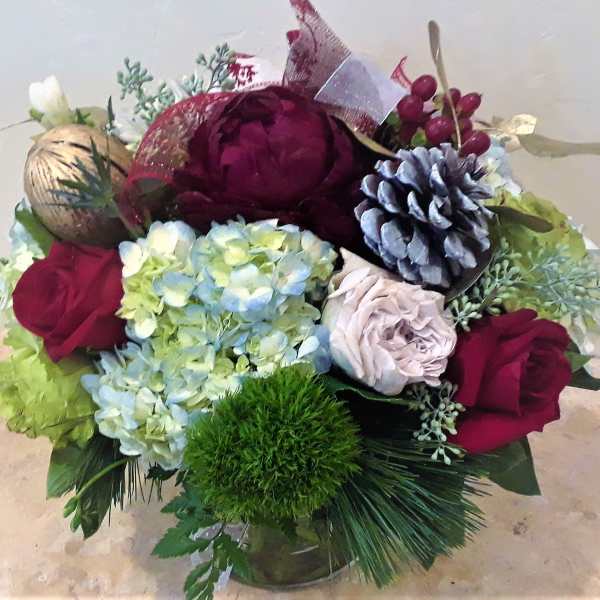 Bouquet of burgundy roses and blue hydrangeas with pinecones