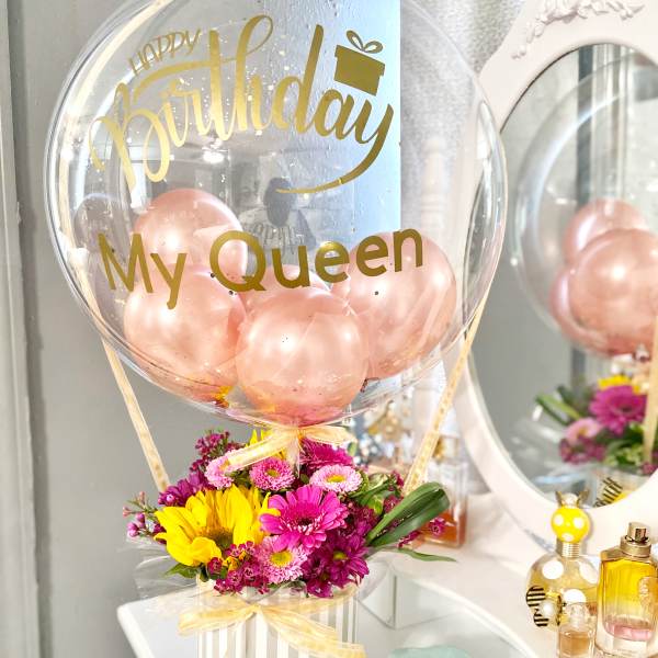 Birthday balloon with pink flowers in a striped box