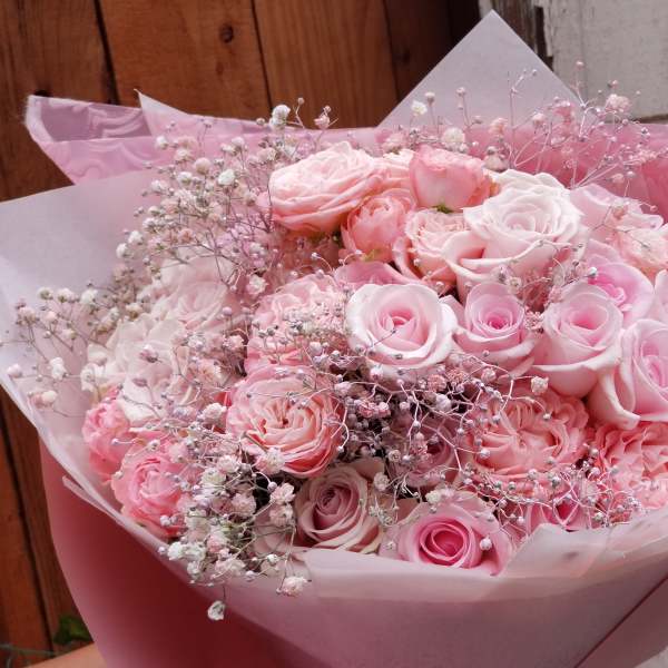 Bouquet of pink roses wrapped in pink paper