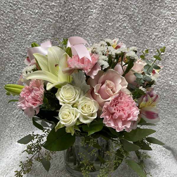 Pink and white mixed flower bouquet in a clear glass vase