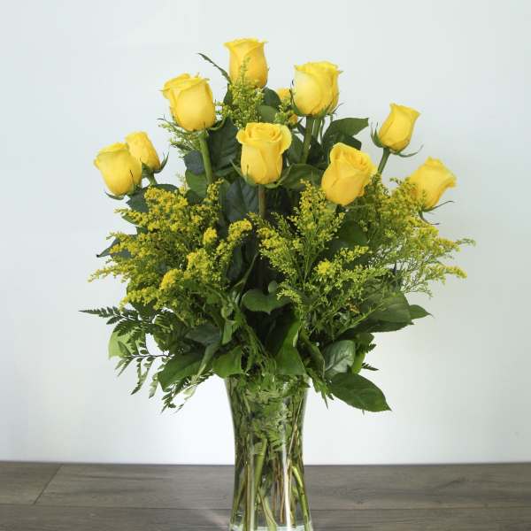 Yellow roses arranged in a clear glass vase