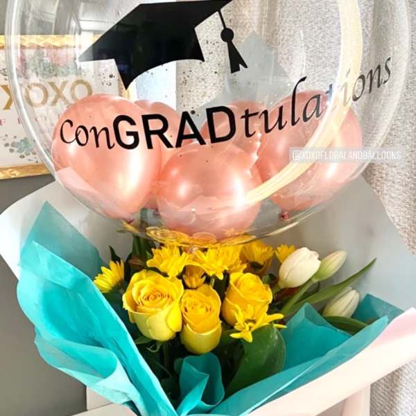 Yellow rose bouquet with a graduation balloon and pink balloons