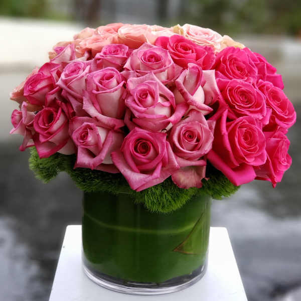 Pink and blush roses arranged in a glass vase