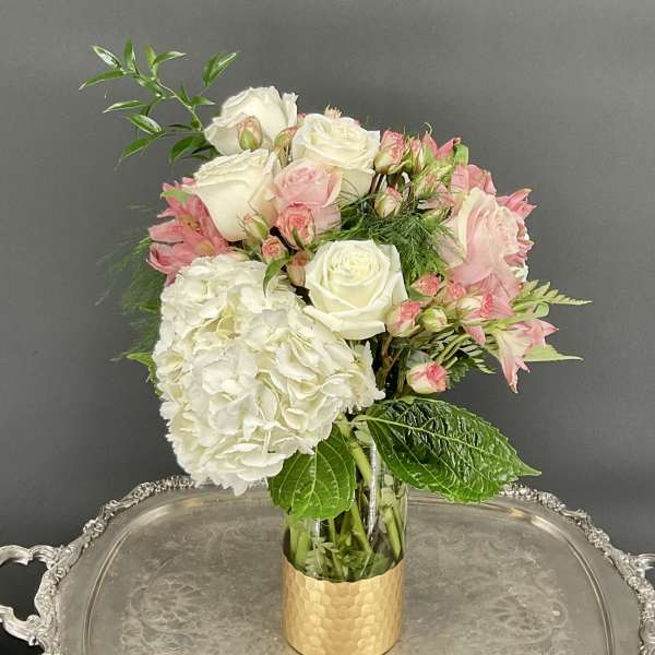 Pink and white bouquet in a gold vase