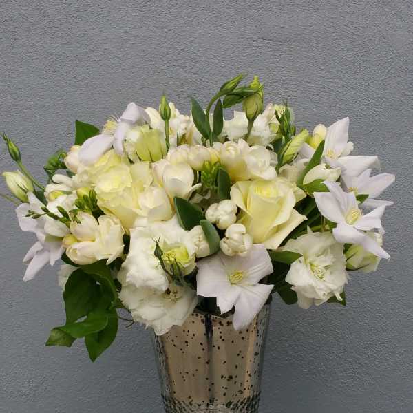 White floral arrangement in a silver vase