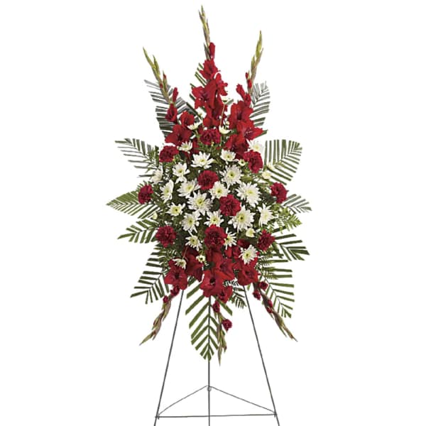 Standing funeral spray with red and white flowers on an easel