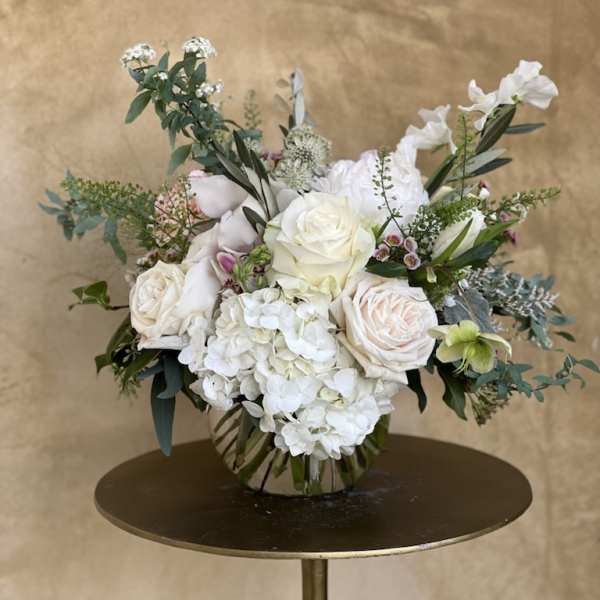 White rose and hydrangea arrangement in a glass vase