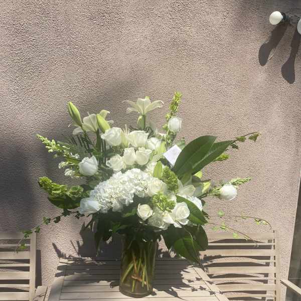 White floral arrangement in a clear glass vase
