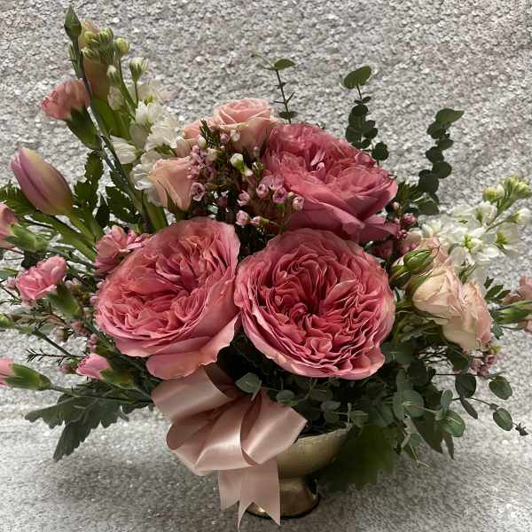 Pink rose bouquet in a gold vase with a satin ribbon