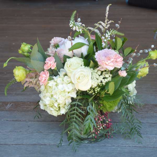 Bouquet of white and pale pink flowers in a glass vase