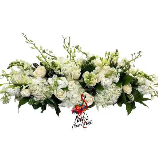 White floral centerpiece with roses and hydrangeas