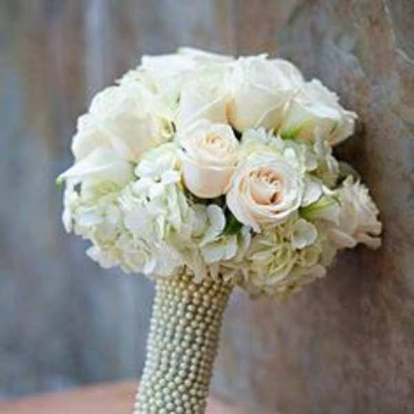 White rose and hydrangea bouquet with a pearl-wrapped handle