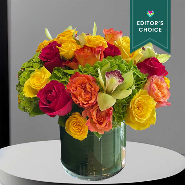 Bright mixed roses and calla lilies in a glass vase
