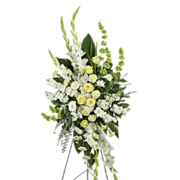 Tall white and pale yellow floral standing spray on an easel