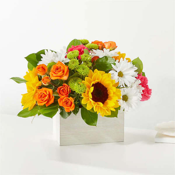 Bright mixed bouquet in a rectangular wooden box