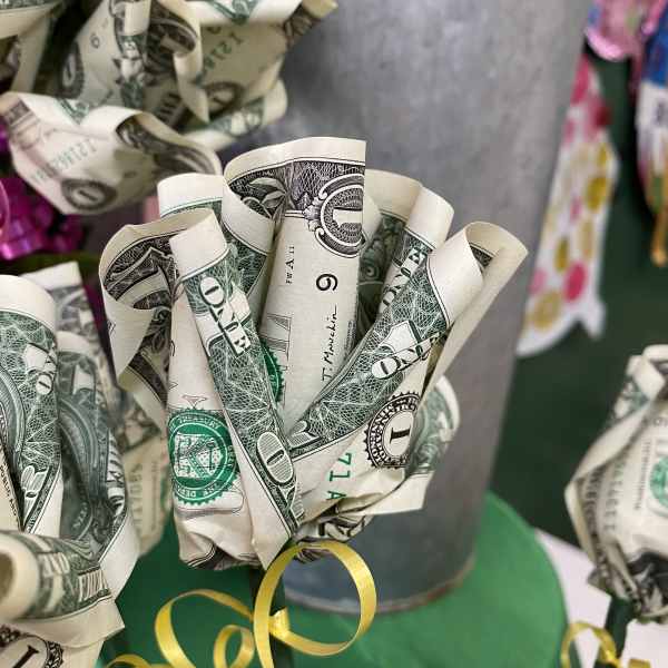 Bouquet made of folded dollar bills with yellow ribbon curls