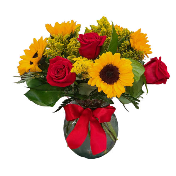 Bouquet of red roses and yellow sunflowers in a glass vase with a red ribbon