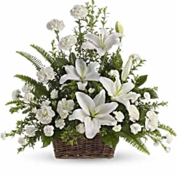 White lilies and carnations in a wicker basket