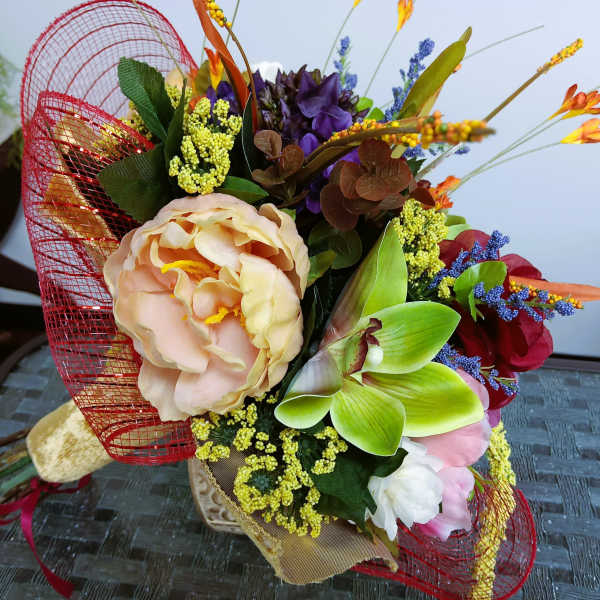 Colorful bouquet with large peach, purple, and green blooms