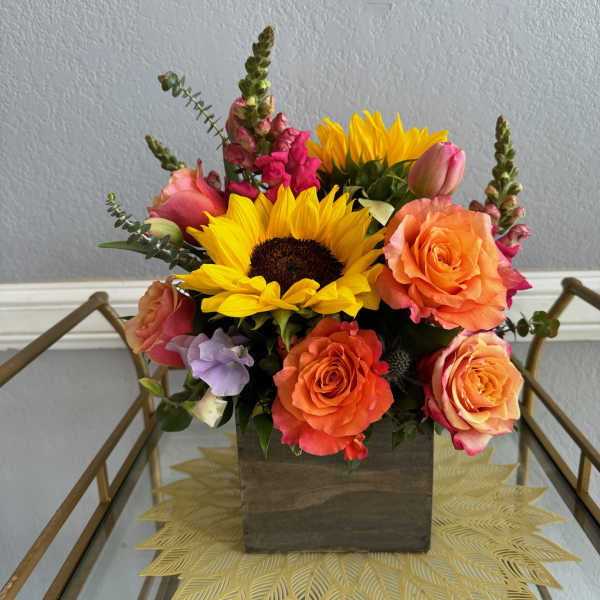 Sunflower and rose arrangement in a wooden box