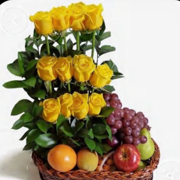 Yellow roses arranged in a basket with assorted fruit