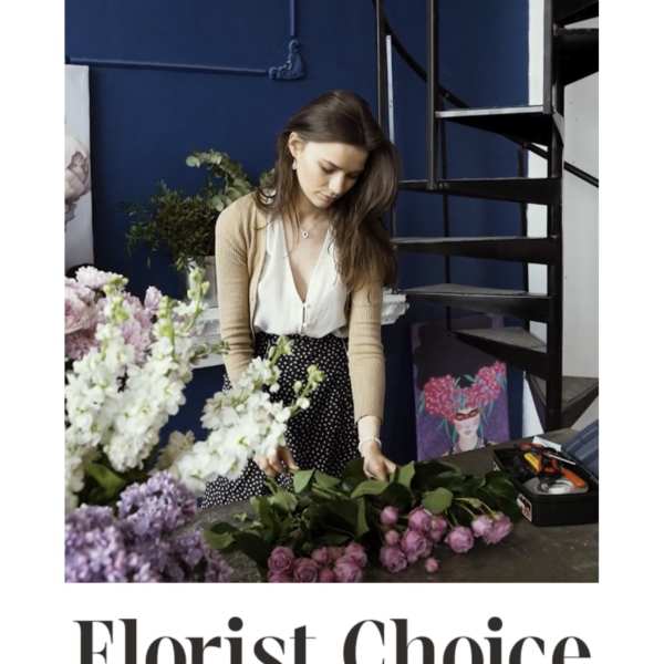 Florist arranging pink and white flowers on a table
