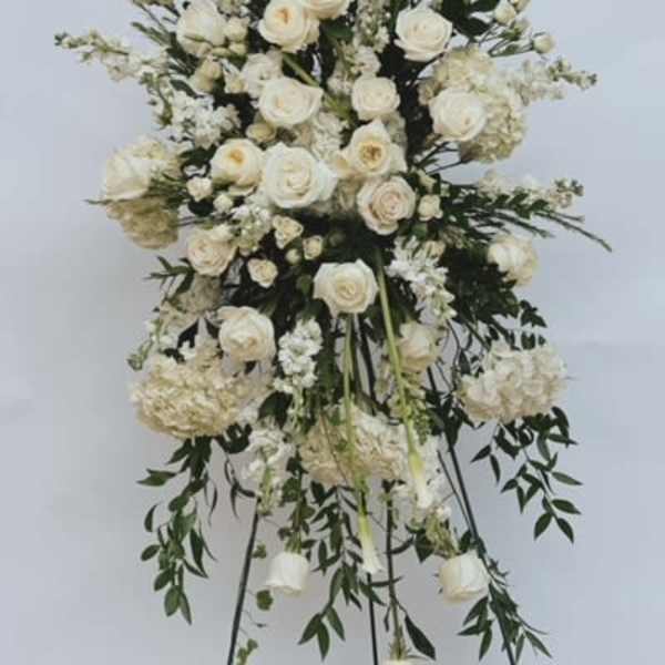Tall white floral standing spray on an easel