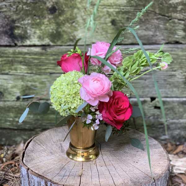 Pink and red roses with green hydrangea in a gold vase