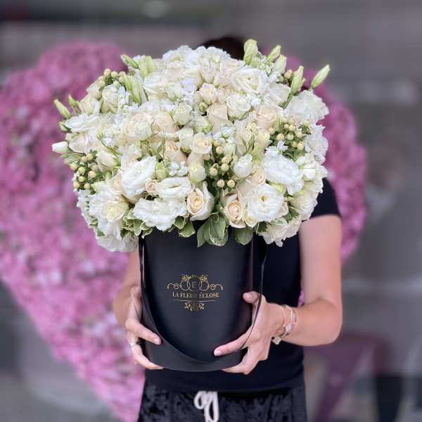 Large white and cream bouquet in a black hatbox