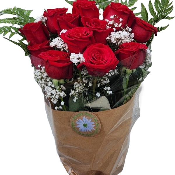 Bouquet of red roses with white baby's breath in brown wrap