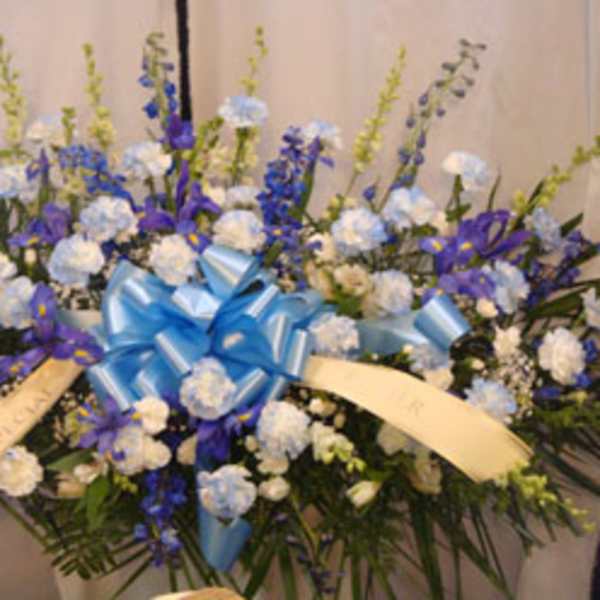 Large blue and white floral spray with ribbon bow
