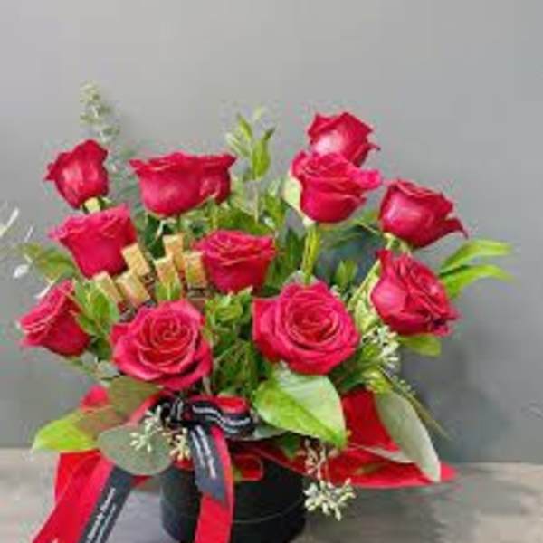 One dozen red roses in a box