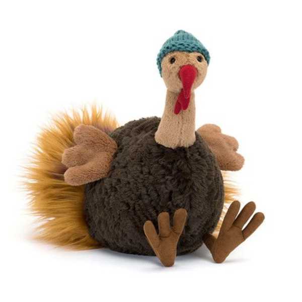 Plush turkey toy with a blue knit hat and red beak