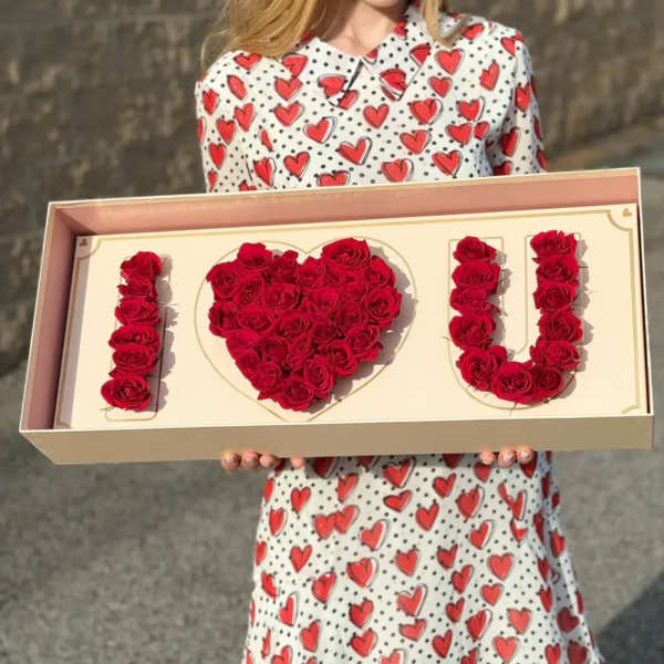 Box of red roses arranged to spell "I ♥ U"