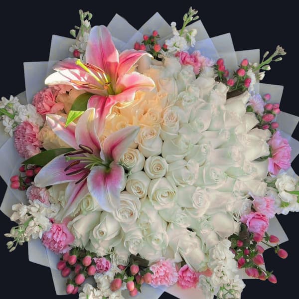 Large bouquet of white roses and pink lilies with pink accents