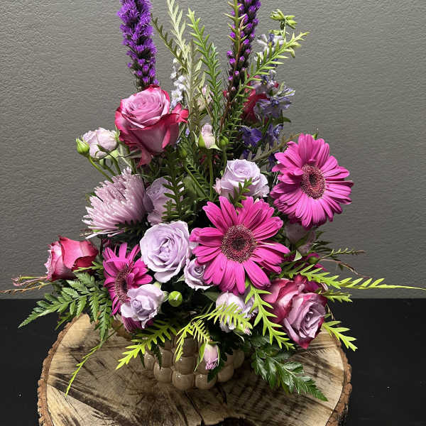 Pink and lavender floral arrangement in a ceramic vase