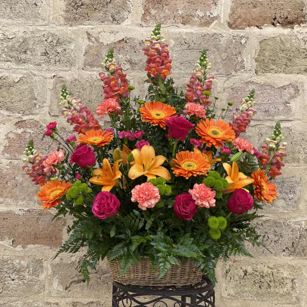 Colorful mixed flower arrangement in a wicker basket