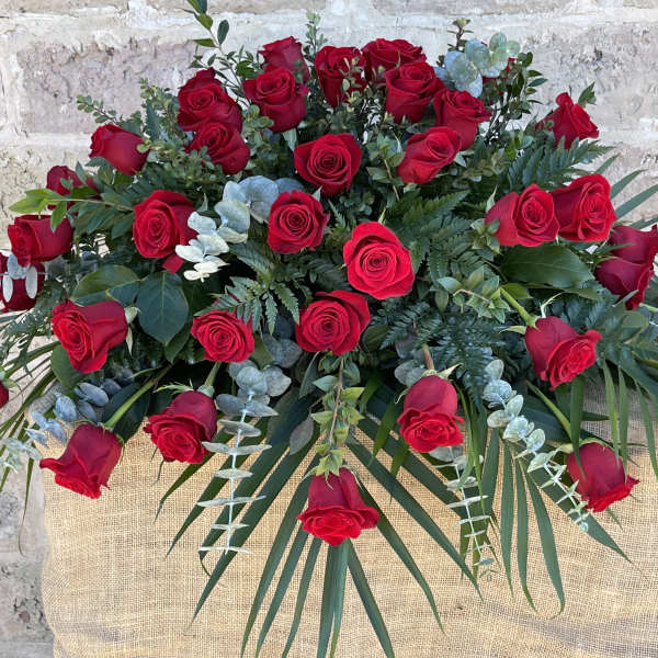 Large bouquet of red roses with eucalyptus and palm fronds