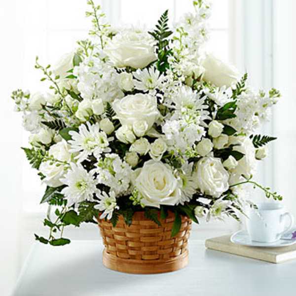 White flower arrangement in a woven basket