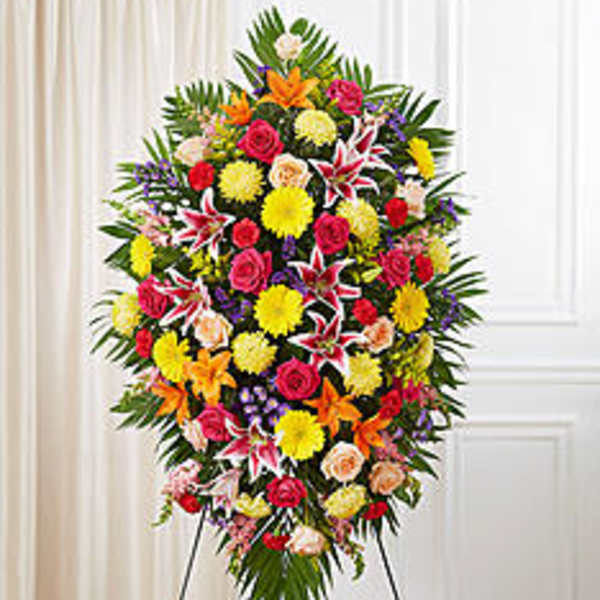 Large standing spray of mixed flowers in bright colors