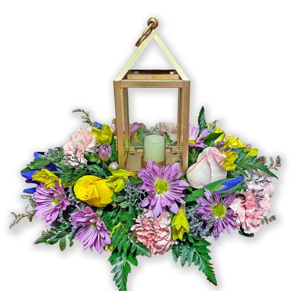 Floral lantern centerpiece with mixed pink, purple, and yellow blooms