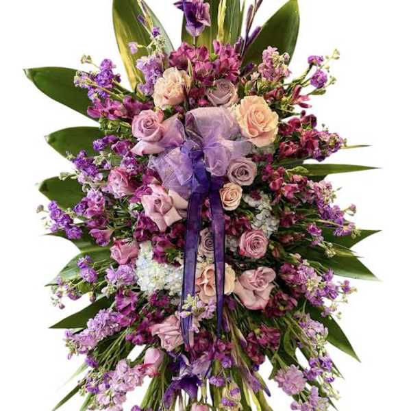 Large purple and pink floral spray with ribbon accents