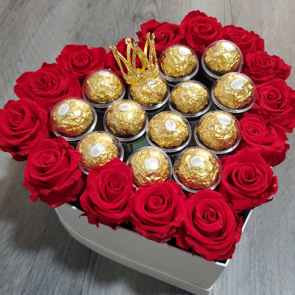 Heart-shaped box of red roses and gold-wrapped chocolates