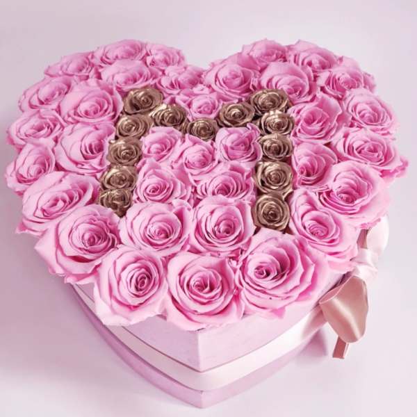 Heart-shaped box of pink roses with gold roses spelling "M"