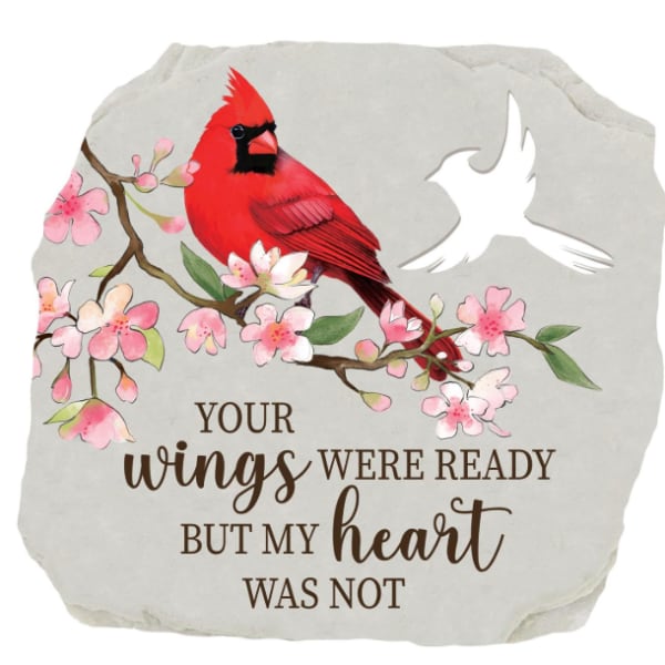 Decorative stone with a red cardinal, pink blossoms, and memorial text