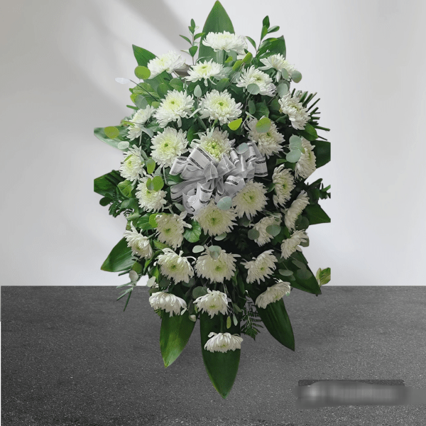 White chrysanthemum standing spray with a white ribbon bow